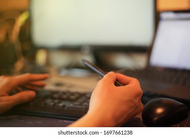 Pointing Laptop Monitor With Digital Pen. Working Seriously With Concentration. Hand Typing On Keyboard Number Pad While Letting Mouse Rest On The Table. Work From Home And Teleconference Concepts. 