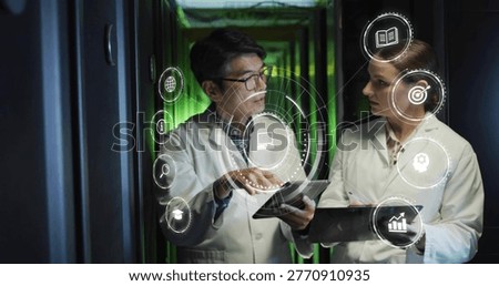 Pointing two technicians in lab coats examining tablets by server racks with green LEDs, AR icons. Datacenter, collaboration, holographic, visualization, professionals, analytics, corridor