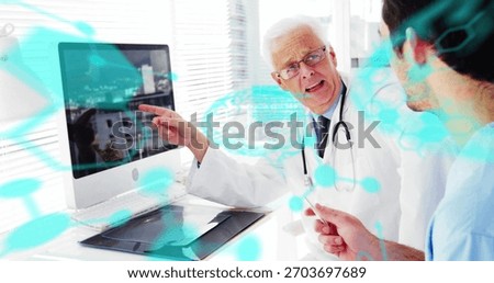 Pointing white-coat doc explaining data to peer in scrubs at clinic, monitor with turquoise-overlay. Physician, clinical, engagement, hightech, office, tablet, stethoscope