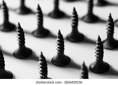 Pointy screws aligned on workshop table