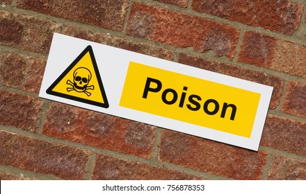"Poison " danger sign on a brick wall background