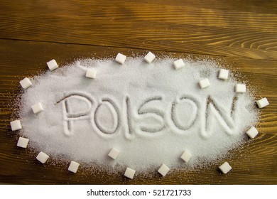 POISON Written On Sugar On Brown Wooden Table. Health Concept