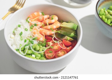 Poke bowl with red shrimps and vegetables in the bowl.Top view. Closeup. High quality photo