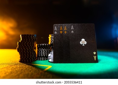 Poker Cards And Chips On The Green Cloth Of The Poker Table. Yellow Background. Focusing On The Foreground. There Are No People In The Photo. Casino, Gambling Business, Poker, Game Strategy.