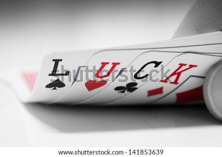 Poker cards with the letters L, U, C, K written on them.