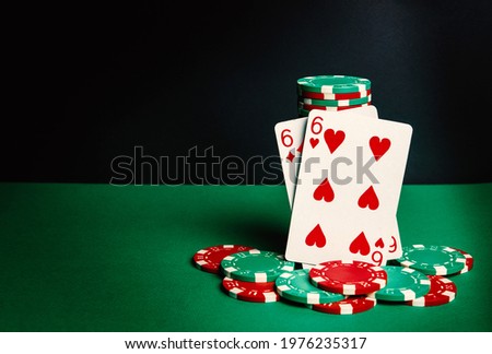 Poker cards with one pair combination. Close-up of playing cards and chips in poker club. Free advertising space
