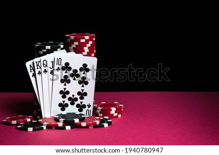 Poker cards with a royal flush combination. Close-up of playing cards and chips in casino. Free advertising space