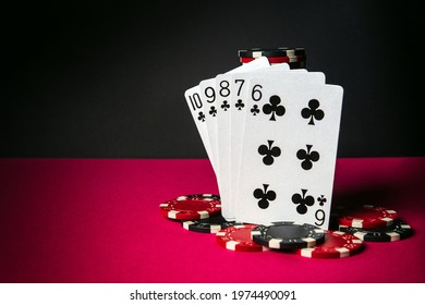 Poker cards with straight flush combination. Close-up of playing cards and chips in poker club. Free advertising space - Shutterstock ID 1974490091
