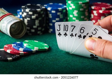 Poker cards with straight flush combination. Close up of gambler hand takes playing cards in casino - Shutterstock ID 2051226077