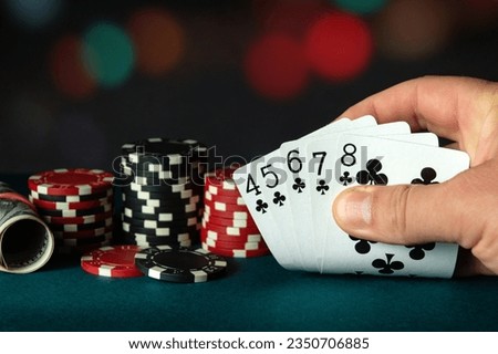 Poker cards with straight flush combination. The player hand holds a winning combination in a game in a poker club. The concept of luck in the poker game.