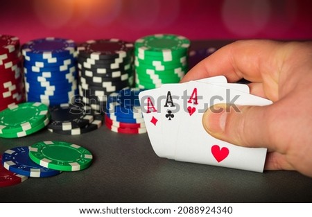 Poker cards with three of a kind or set combination. Close up of gambler hand takes playing cards in poker club