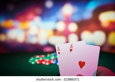 Poker chips with aces cards on table in casino