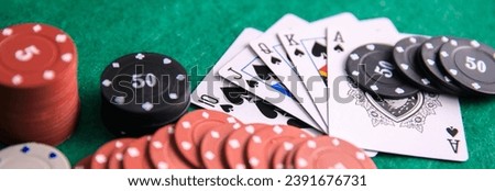 poker chips and cards on the green table background