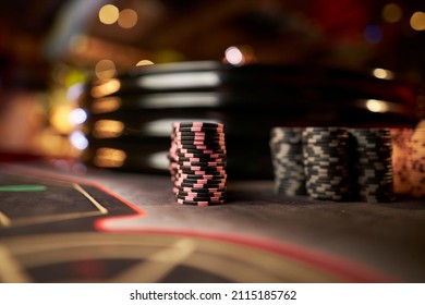 Poker chips colorful gaming pieces lie on the game table in the stack. Background for gambling, casino, business, poker. Colorful casino chips for casino game on the table. Soft focus - Powered by Shutterstock