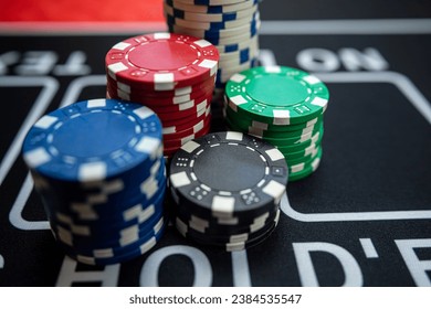 poker chips stack  on a black casino table. Poker game theme, gambling concept. Win and luck - Powered by Shutterstock