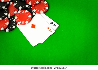 Poker cloth, a deck of cards, poker hand and chips. Background.