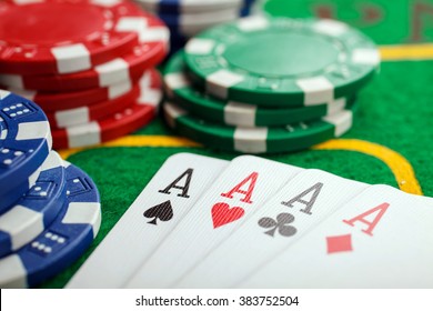 poker four aces on green casino table