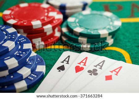 poker four aces on green casino table