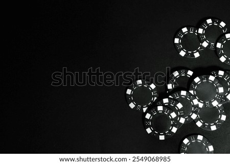 Poker game. Casino chips on black table, top view. Space for text