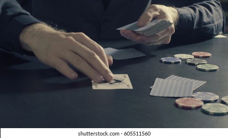 Poker Game - Dealing Cards. Man's Hands Dealing Cards And Chips. Close Up