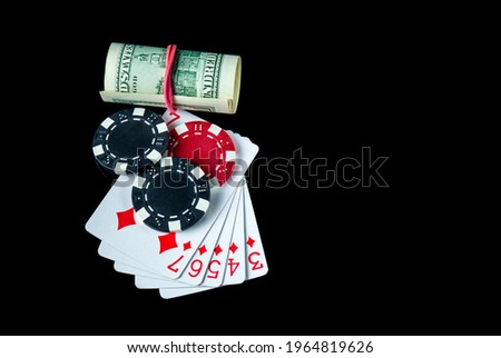 Poker game with straight flush combination and money. Chips and cards on the black table. Winnings in poker