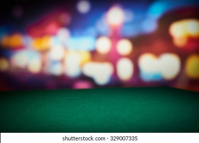 Poker green table in casino with blur background