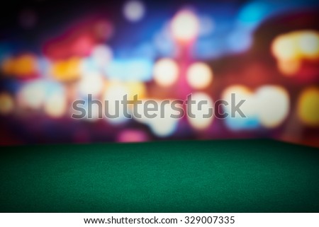 Poker green table in casino with blur background