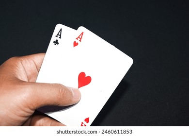 poker pair aces , isolated black background. playing cards, hand holding pair aces - Powered by Shutterstock