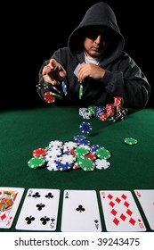 Poker played with hood and sunglasses throwing chips on stack