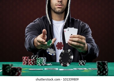 Poker player, on a red background, throwing poker chips.