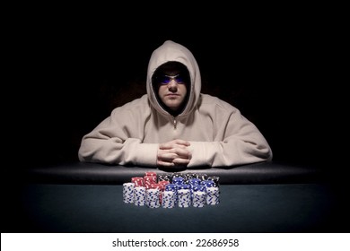 a poker player sitting at a table trying to hide his expressions