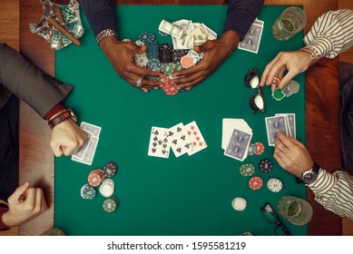 Poker players hands with cards, top view - Powered by Shutterstock