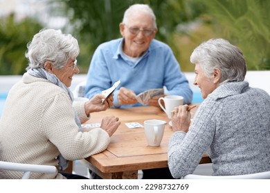 Poker, smile and senior group with retirement, outdoor and cheerful together with joy, relax and playful. Elderly people, old man and mature women outside, card games and chilling with social bonding - Powered by Shutterstock