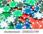 Poker Table With Poker Chips Turns In Casino Many Poker Chips Spins on the Table in Darkness. with a winning combination in poker on a black table and chips in the background. on a gaming