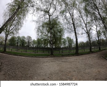 Oświęcim / Poland - April 27, 2019 - Electric fence with barbed wire and Air Raid Shelter in Auschwitz I German Nazi Concentration and Extermination Camp on the outskirts of Oswiecim, Poland. 