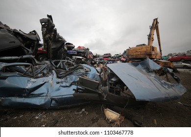 POLAND, CIRCA 2018. Excavators and other equipment at the scrap yard. A heap of scrap metal, metal shards, tires and car engines. - Shutterstock ID 1103467778