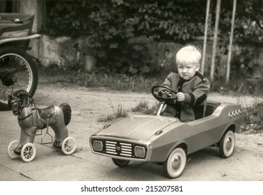 POLAND, CIRCA Eighties: Vintage Photo Of Little Boy In Toy Car