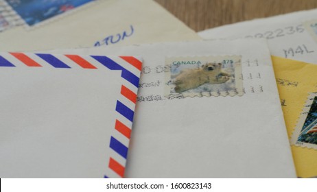 POLAND - DECEMBER 2019: Stack of old fashioned paper letters with Canadian post stamp