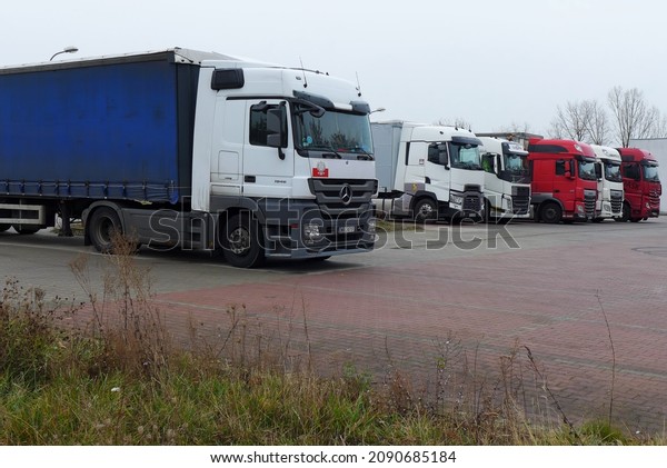 Poland, Chojnów, December 2021. Several trucks\
parked in the parking lot. No\
people.