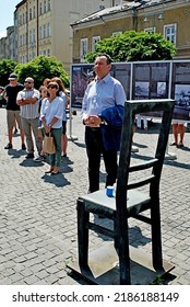 KRAKÓW, POLAND - July 2022. Holocaust Memorial - Ghetto Heroes Square. Art Installation From 2005  - Cast-iron Chairs Reminding Us Of What Was Left After The Liquidation Of The Krakow Ghetto.