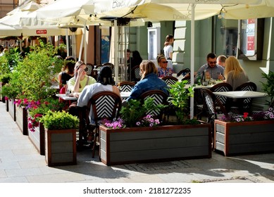 KRAKÓW, POLAND - July 2022. Tourists At The Historic Main Square. In The Heart Of Krakow's Old Town. UNESCO List 1978.  