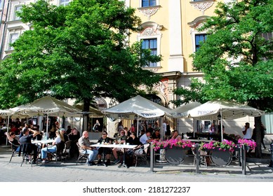 KRAKÓW, POLAND - July 2022. Tourists At The Historic Main Square. In The Heart Of Krakow's Old Town. UNESCO List 1978.  