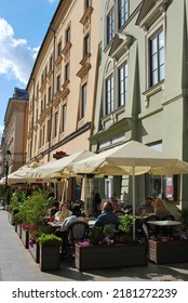 KRAKÓW, POLAND - July 2022. Tourists At The Historic Main Square. In The Heart Of Krakow's Old Town. UNESCO List 1978.  