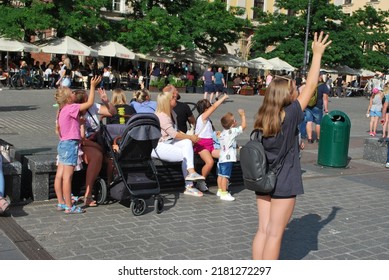 KRAKÓW, POLAND - July 2022. Tourists At The Historic Main Square. In The Heart Of Krakow's Old Town. UNESCO List 1978.  