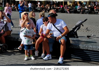 KRAKÓW, POLAND - July 2022. Tourists At The Historic Main Square. In The Heart Of Krakow's Old Town. UNESCO List 1978.  