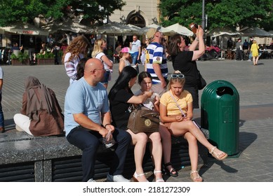 KRAKÓW, POLAND - July 2022. Tourists At The Historic Main Square. In The Heart Of Krakow's Old Town. UNESCO List 1978.  