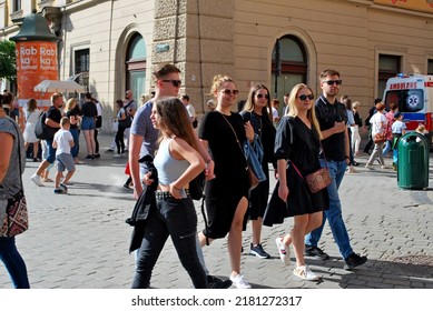 KRAKÓW, POLAND - July 2022. Tourists At The Historic Main Square. In The Heart Of Krakow's Old Town. UNESCO List 1978.  