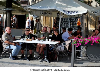 KRAKÓW, POLAND - July 2022. Tourists At The Historic Main Square. In The Heart Of Krakow's Old Town. UNESCO List 1978.  