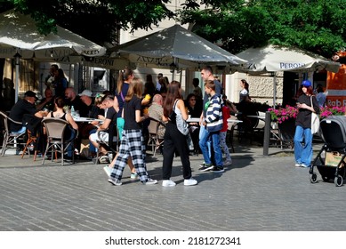 KRAKÓW, POLAND - July 2022. Tourists At The Historic Main Square. In The Heart Of Krakow's Old Town. UNESCO List 1978.  