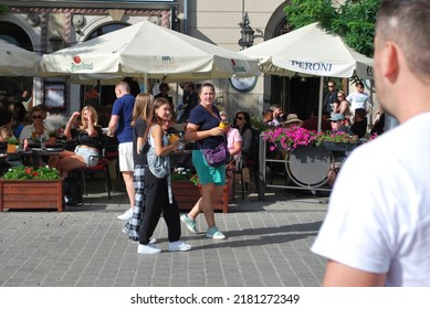 KRAKÓW, POLAND - July 2022. Tourists At The Historic Main Square. In The Heart Of Krakow's Old Town. UNESCO List 1978.  